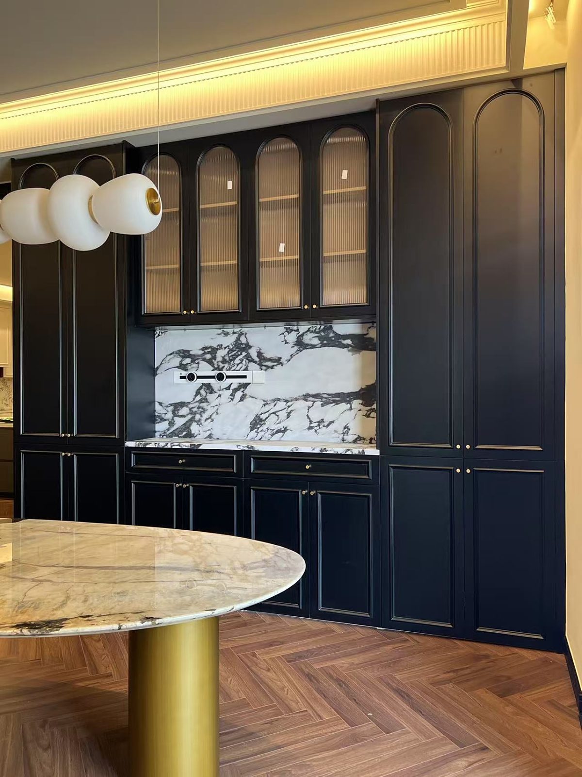 Dark cabinetry kitchen with marble backsplash