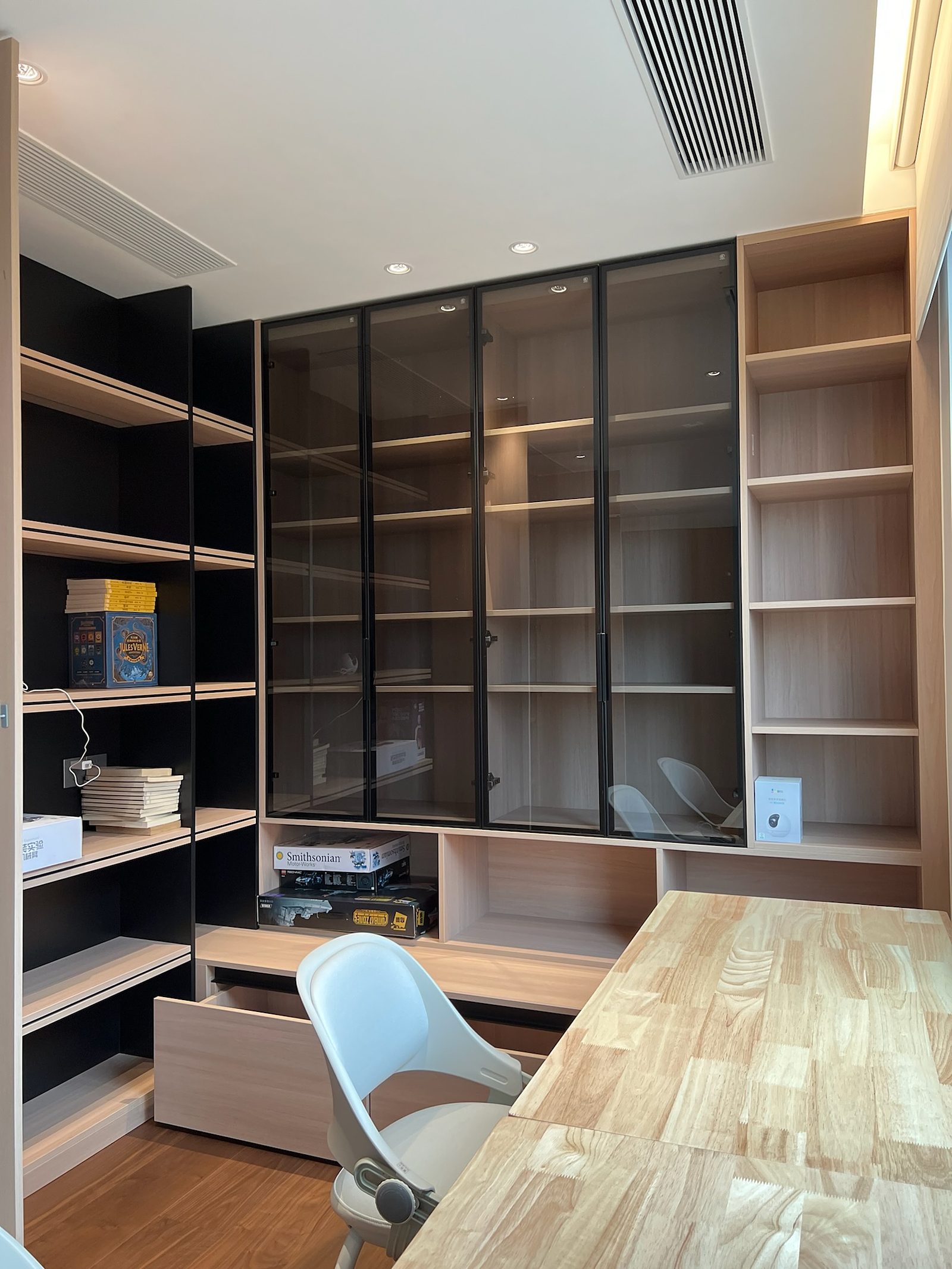 Study room with glass-door display cabinetry and desk
